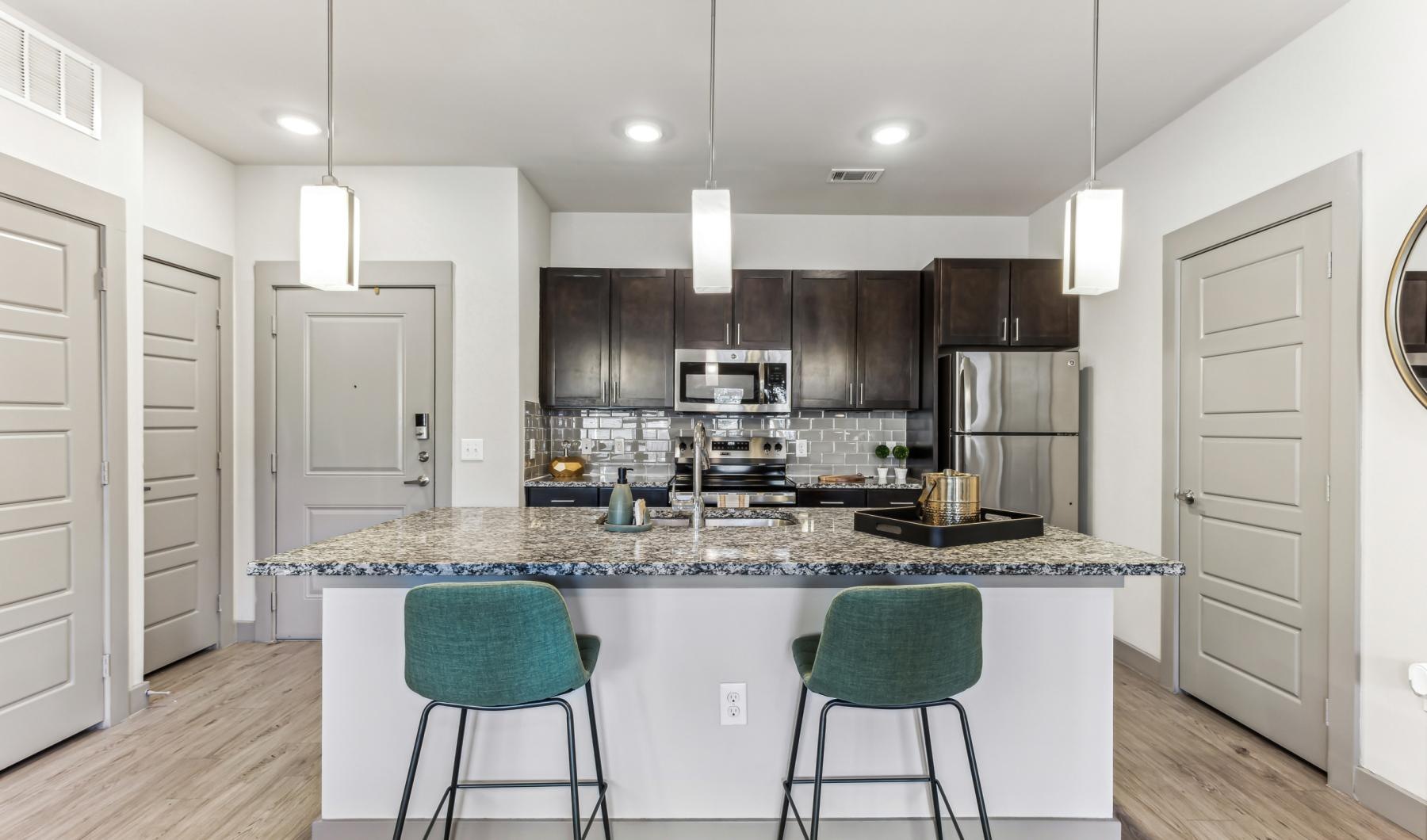 a kitchen with a marble island