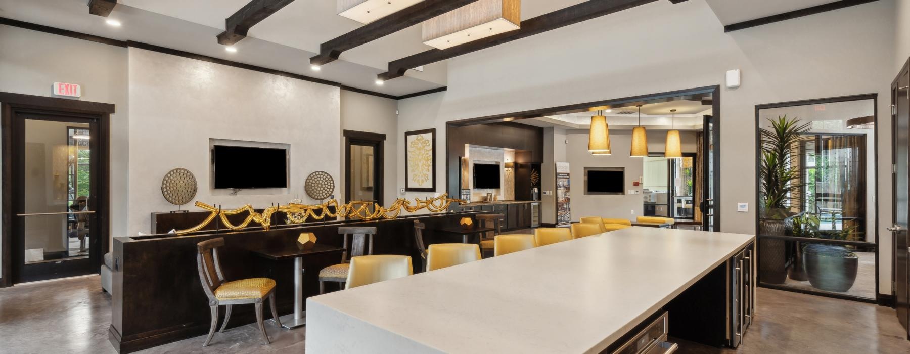 a kitchen with a bar and chairs