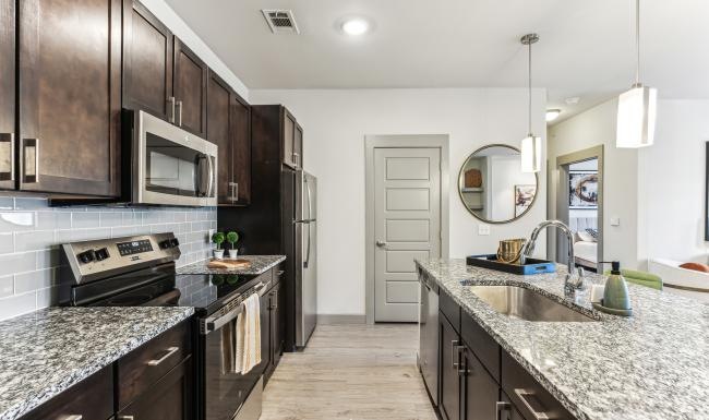 a kitchen with black cabinets