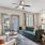 a living room with a couch and a fan