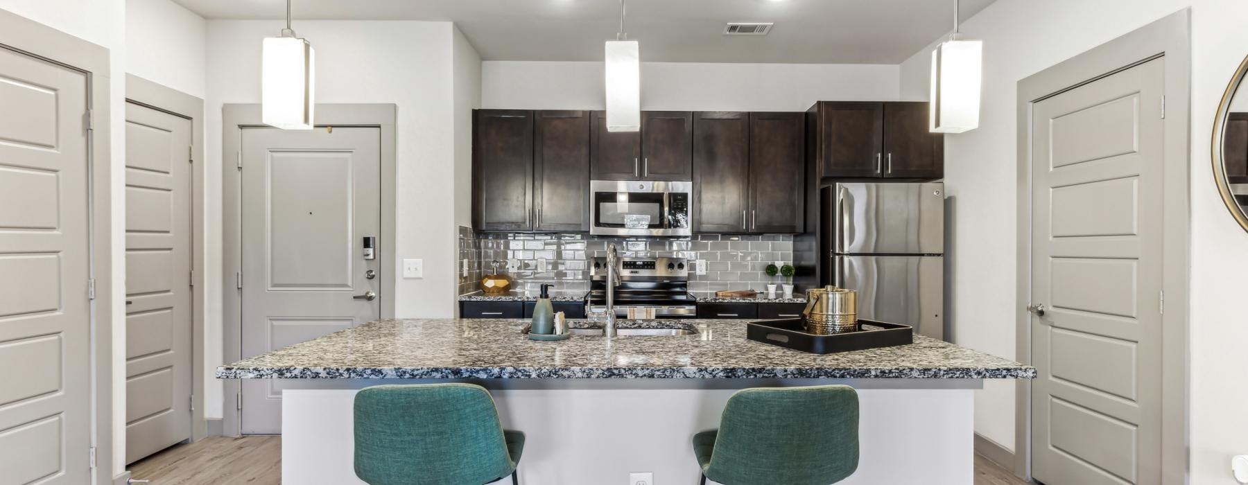 a kitchen with a marble island