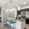 a kitchen with a bar and chairs